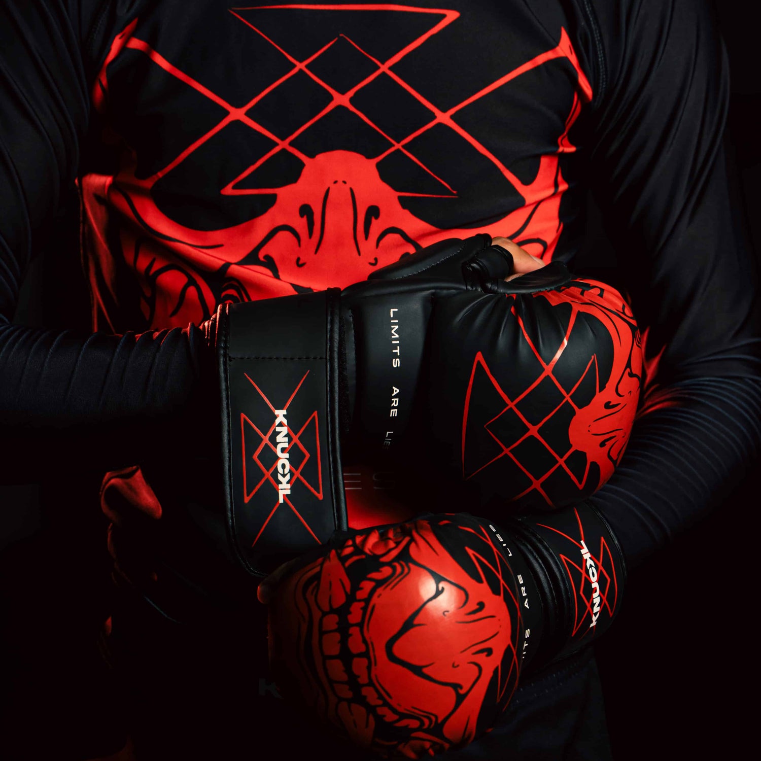 Boxer wearing Knuckl Oni boxing gloves in a dramatic dark-themed pose with red and black gear