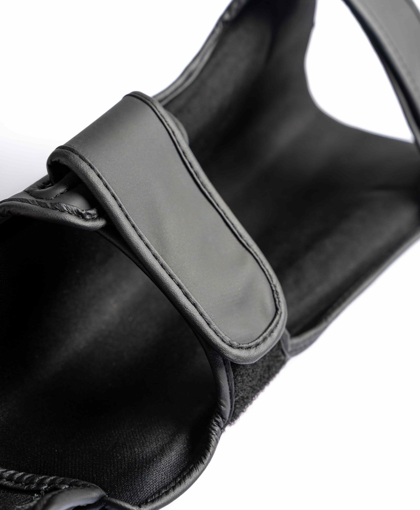 Interior view of Knuckl shin guard showing strap and padding